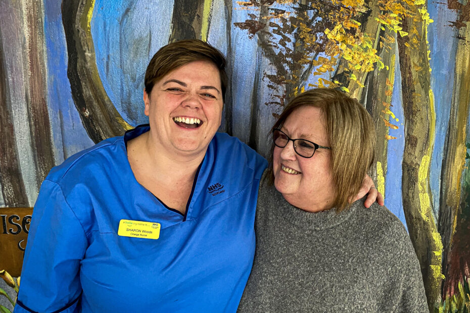 Charge Nurse Sharon Woods and Health Care Support Worker Caroline Swan smiling and laughing in Ward 56 at the QEUH