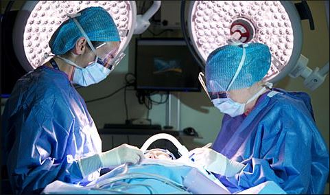 Image of operating theatre with two surgeons and a patient