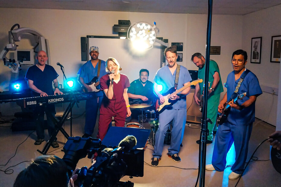 A band in NHS staff uniforms are filmed performing the song for the video.