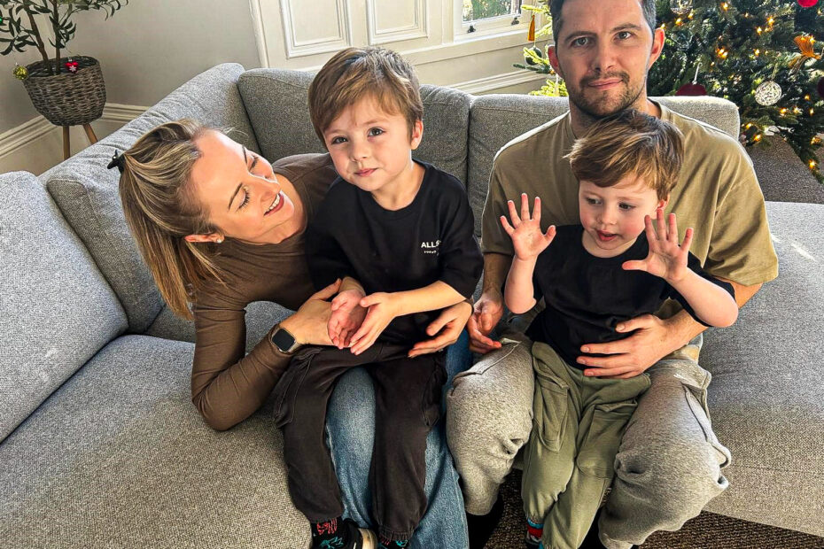 Scott Gold, his wife and two sons, sitting smiling on the settee at their Paisley home